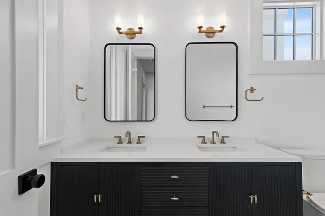 an aerial view of residential houses with outdoor space and ocean view