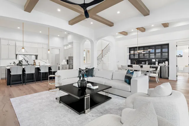 a living room with furniture and a view of kitchen