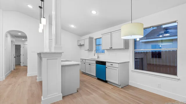 a kitchen with a stove a refrigerator and a fireplace