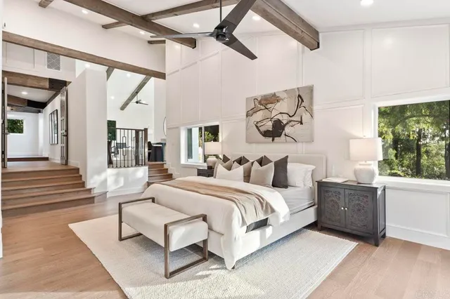 a spacious bedroom with a large bed and a couch