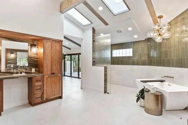 a bathroom with a sink a mirror and shower