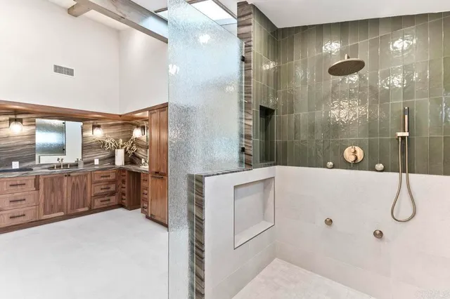 a bathroom with a double vanity sink a large mirror and shower