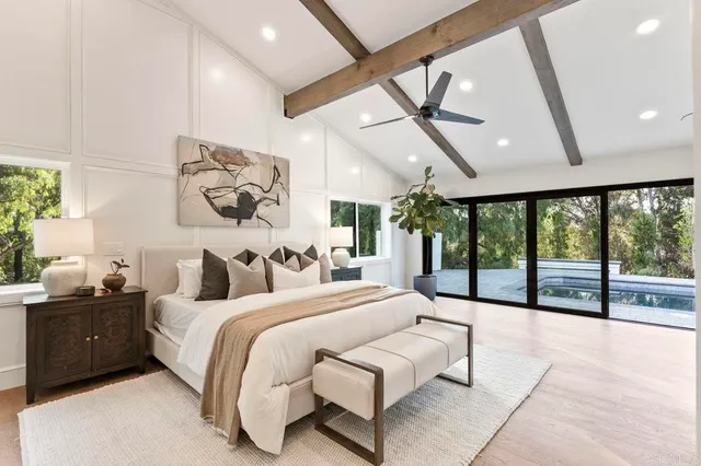 a bedroom with a large bed and a large window