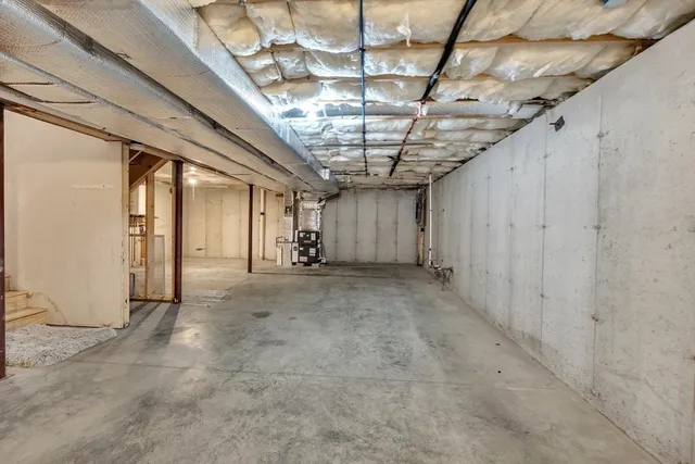 a view of empty room with wooden ceiling