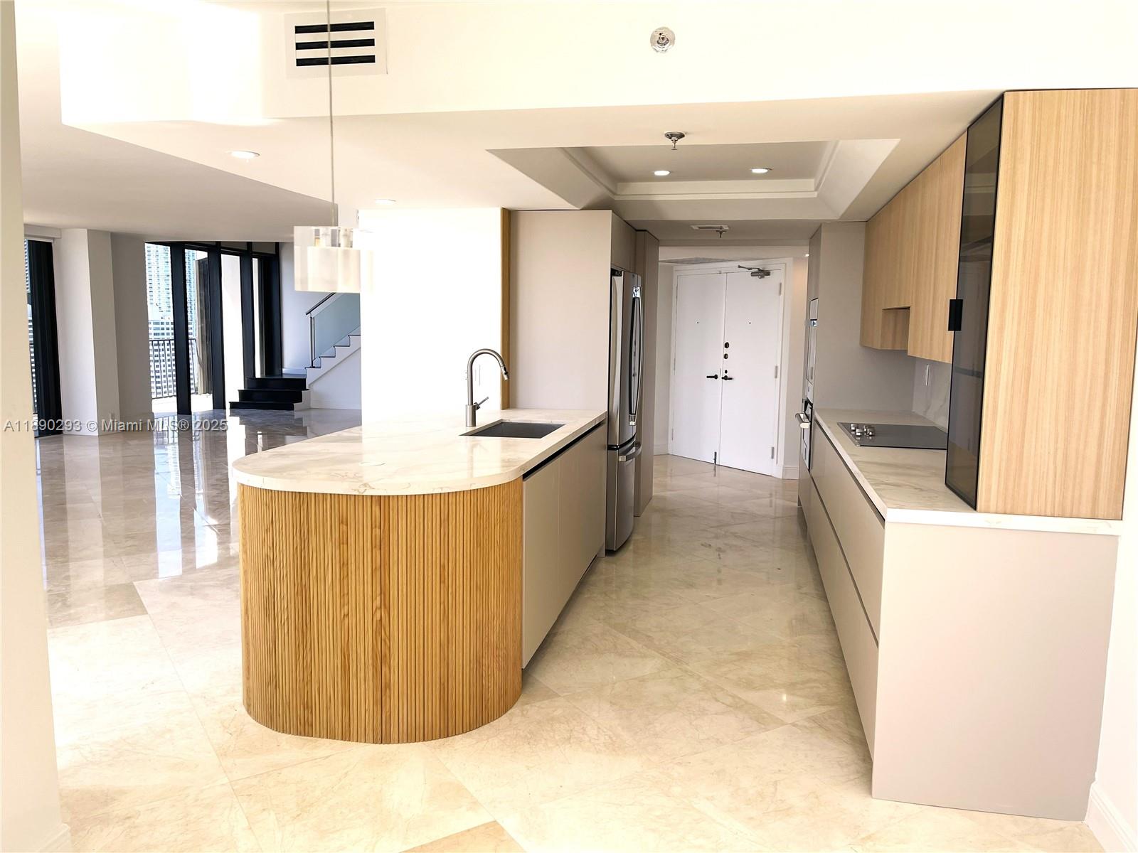 520 Brickell Key Drive, Unit UPH03 Miami, FL 33131 - Photo 13 of 35 a large kitchen with kitchen island a sink a counter top space and stainless steel appliances