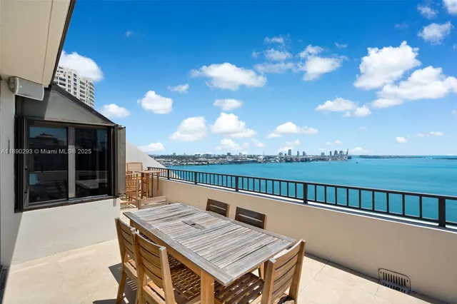 a view of a balcony with two chairs and a table