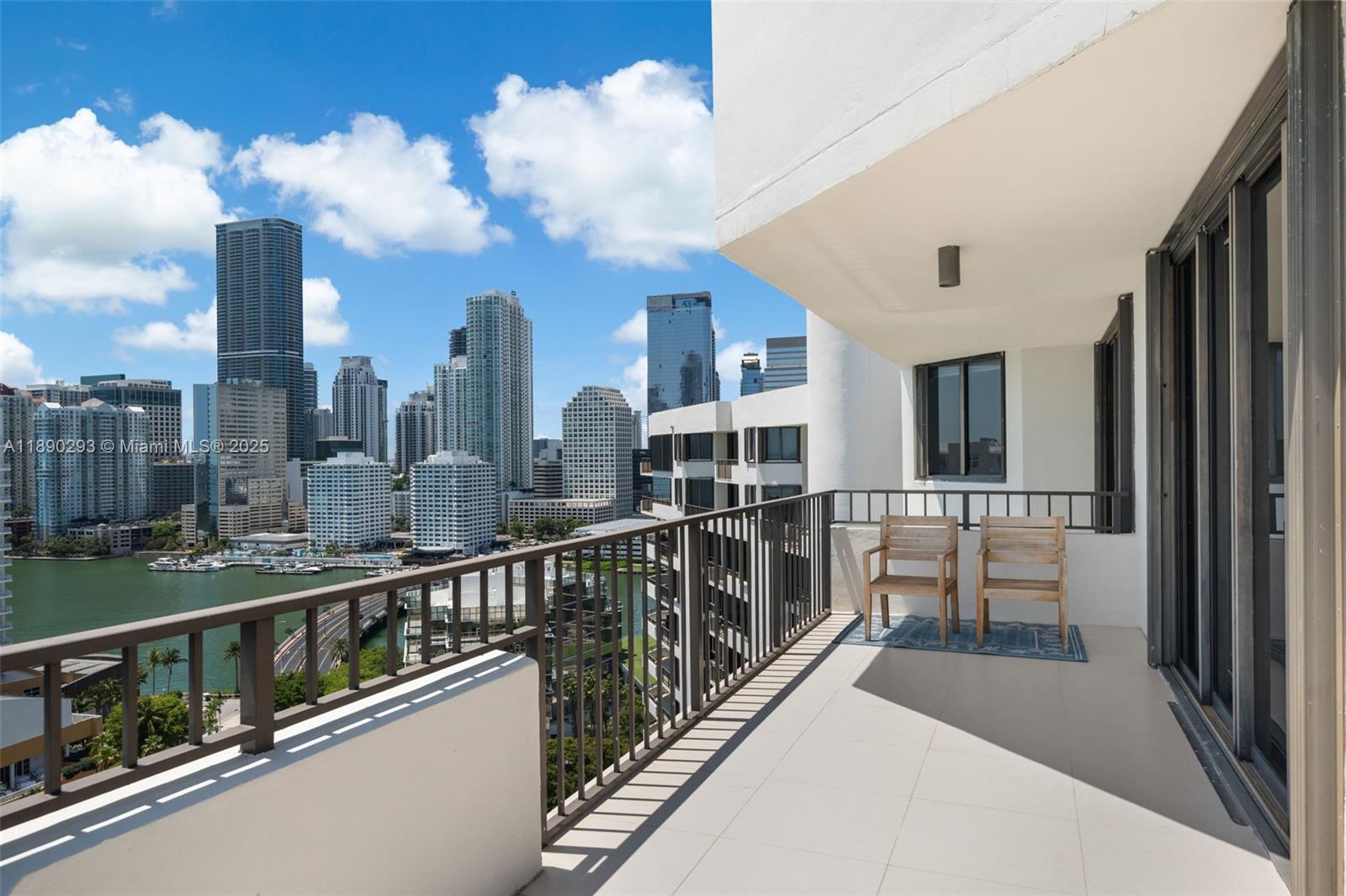 520 Brickell Key Drive, Unit UPH03 Miami, FL 33131 - Photo 19 of 35 a view of a balcony with two chairs and a table