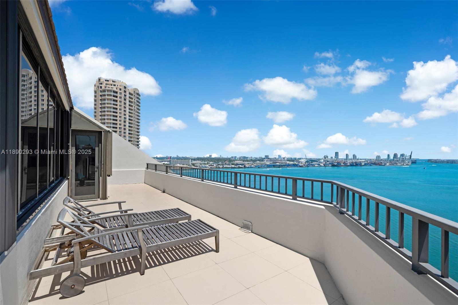 520 Brickell Key Drive, Unit UPH03 Miami, FL 33131 - Photo 22 of 35 a view of a balcony with wooden floor