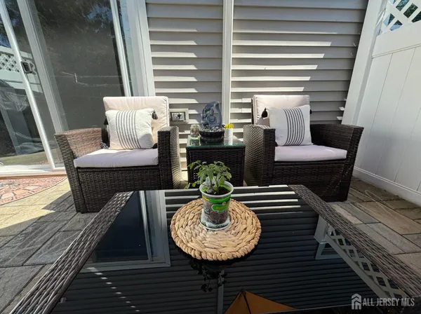 a view of a balcony with chairs and a potted plant