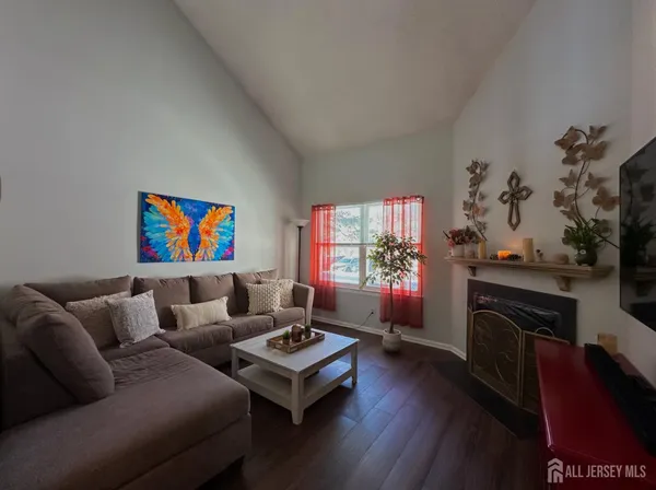 a living room with furniture fireplace and flat screen tv