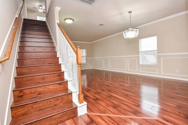 a view of entryway and hall with wooden floor