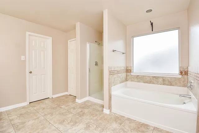 a white bath tub sitting next to a bathroom