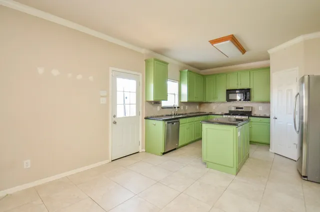 a kitchen with a sink and a refrigerator