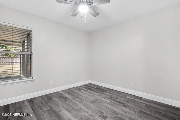 wooden floor in an empty room with a window