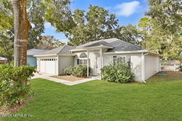 a front view of house with yard and green space