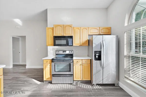 a kitchen with stainless steel appliances a refrigerator stove and sink