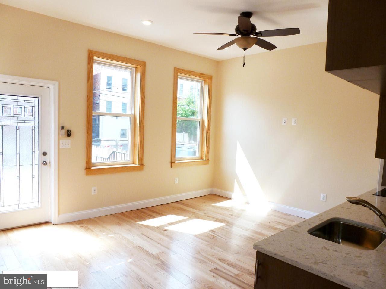 1102 5th Street Northwest, Unit 2 Washington, DC 20001 - Photo 2 of 9 a view of empty room with wooden floor and fan