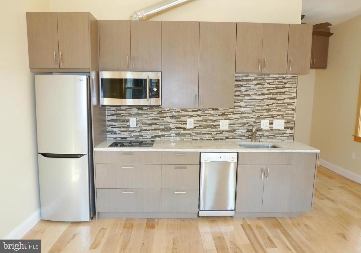 1102 5th Street Northwest, Unit 2 Washington, DC 20001 - Photo 4 of 9 a kitchen with stainless steel appliances granite countertop a refrigerator a stove and a sink