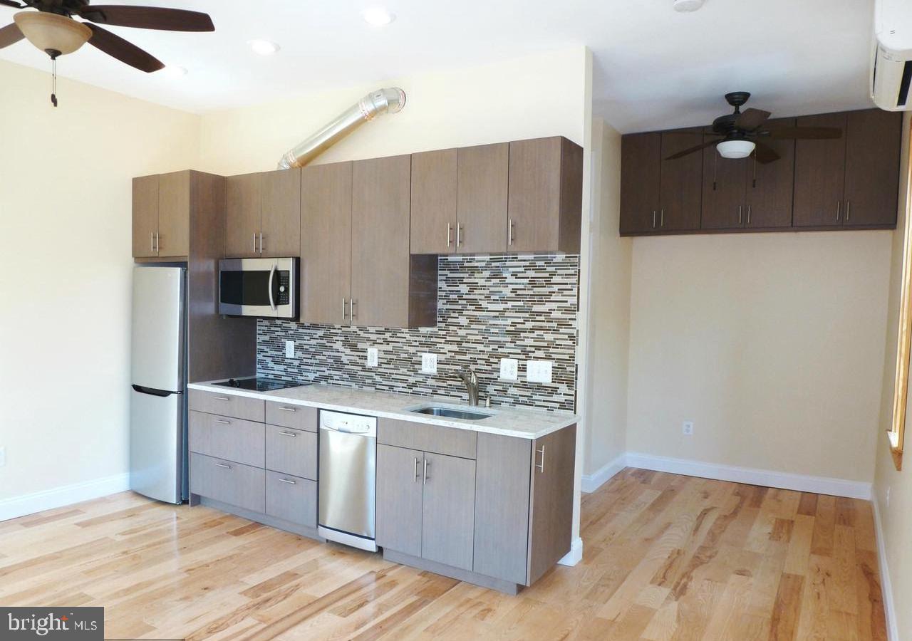 1102 5th Street Northwest, Unit 2 Washington, DC 20001 - Photo 5 of 9 a kitchen with stainless steel appliances granite countertop a stove and a refrigerator