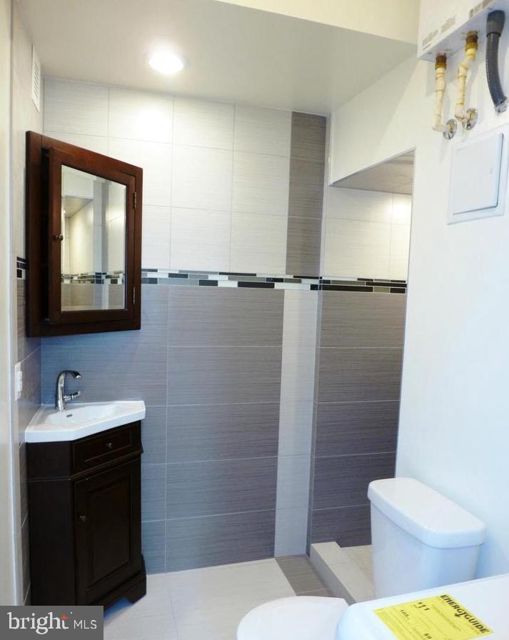 1102 5th Street Northwest, Unit 2 Washington, DC 20001 - Photo 7 of 9 a bathroom with a sink toilet and shower