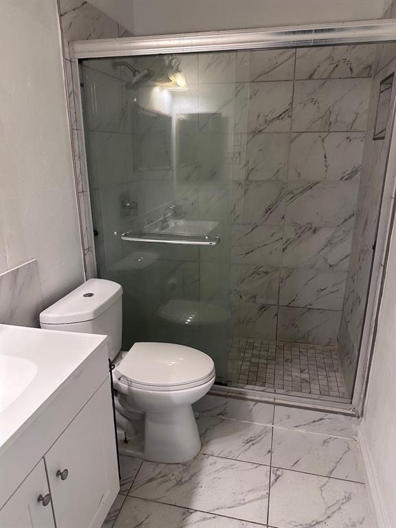 2103 Carlton Road Carrollton, TX 75007 - Photo 12 of 18 a bathroom with a toilet and a shower