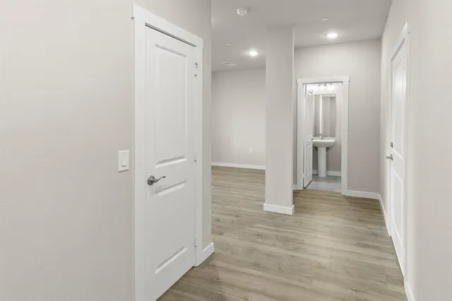 a view of a hallway with wooden floor