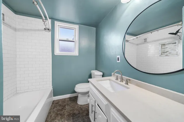 a bathroom with a sink toilet and tub