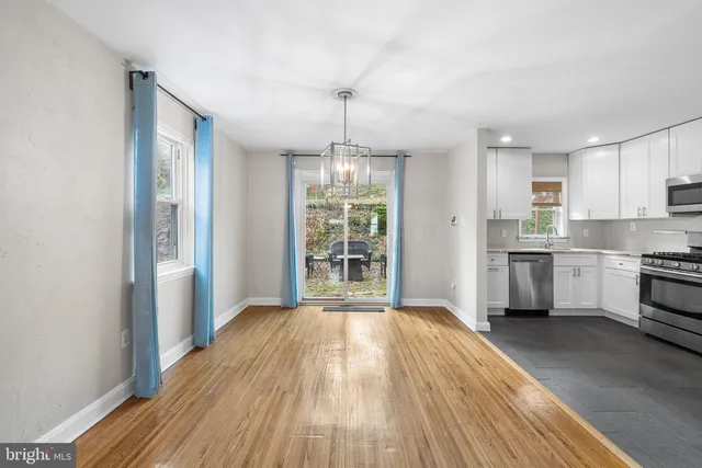 a kitchen that has a lot of cabinets and wooden floor
