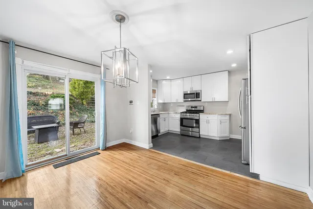 a kitchen with stainless steel appliances granite countertop a refrigerator and a stove top oven