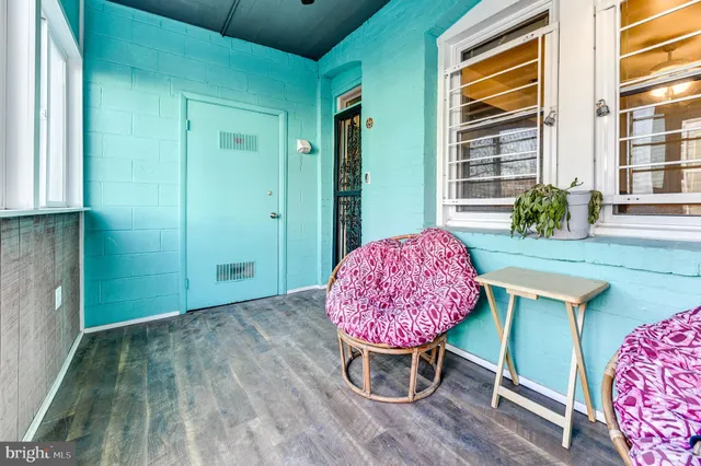 a view of a room with a table and chairs