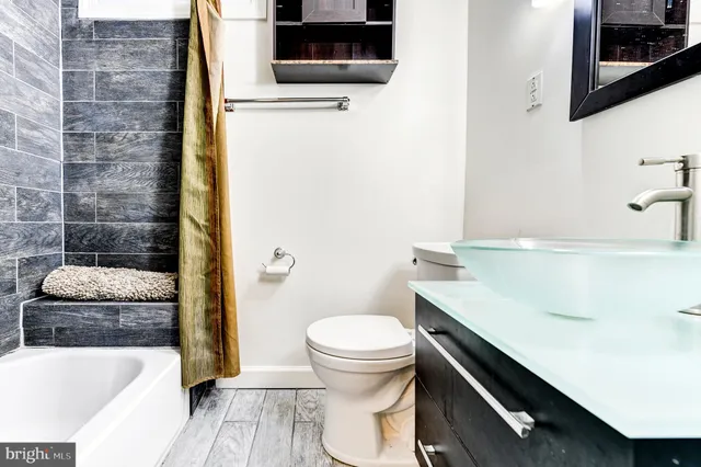 a bathroom with a sink a toilet a shower and bathtub