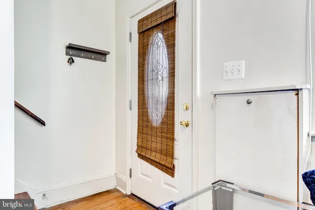 a view of a hallway with wooden floor and door