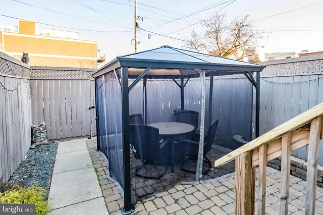a wooden bench sitting in front of a building