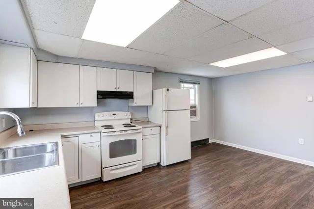 a kitchen with a stove a sink and a refrigerator