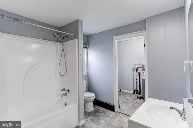 a bathroom with a sink a toilet and a bathtub