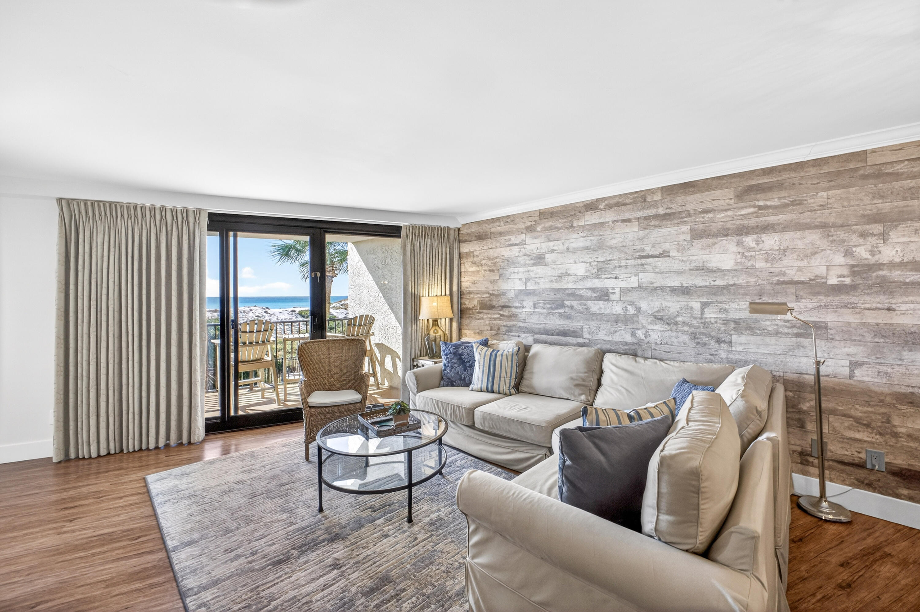 4024 Beachside 1, Unit 4024 Miramar Beach, FL 32550 - Photo 12 of 56 a living room with furniture and a floor to ceiling window