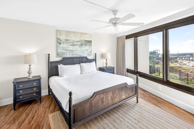 a view of a hallway with closet and wooden floor