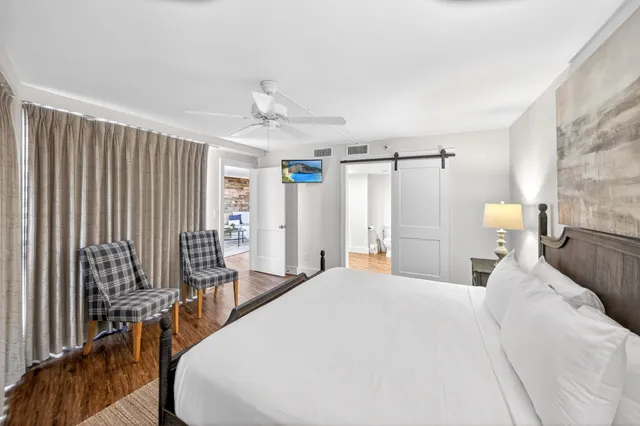 a bedroom with a bed and a flat screen tv