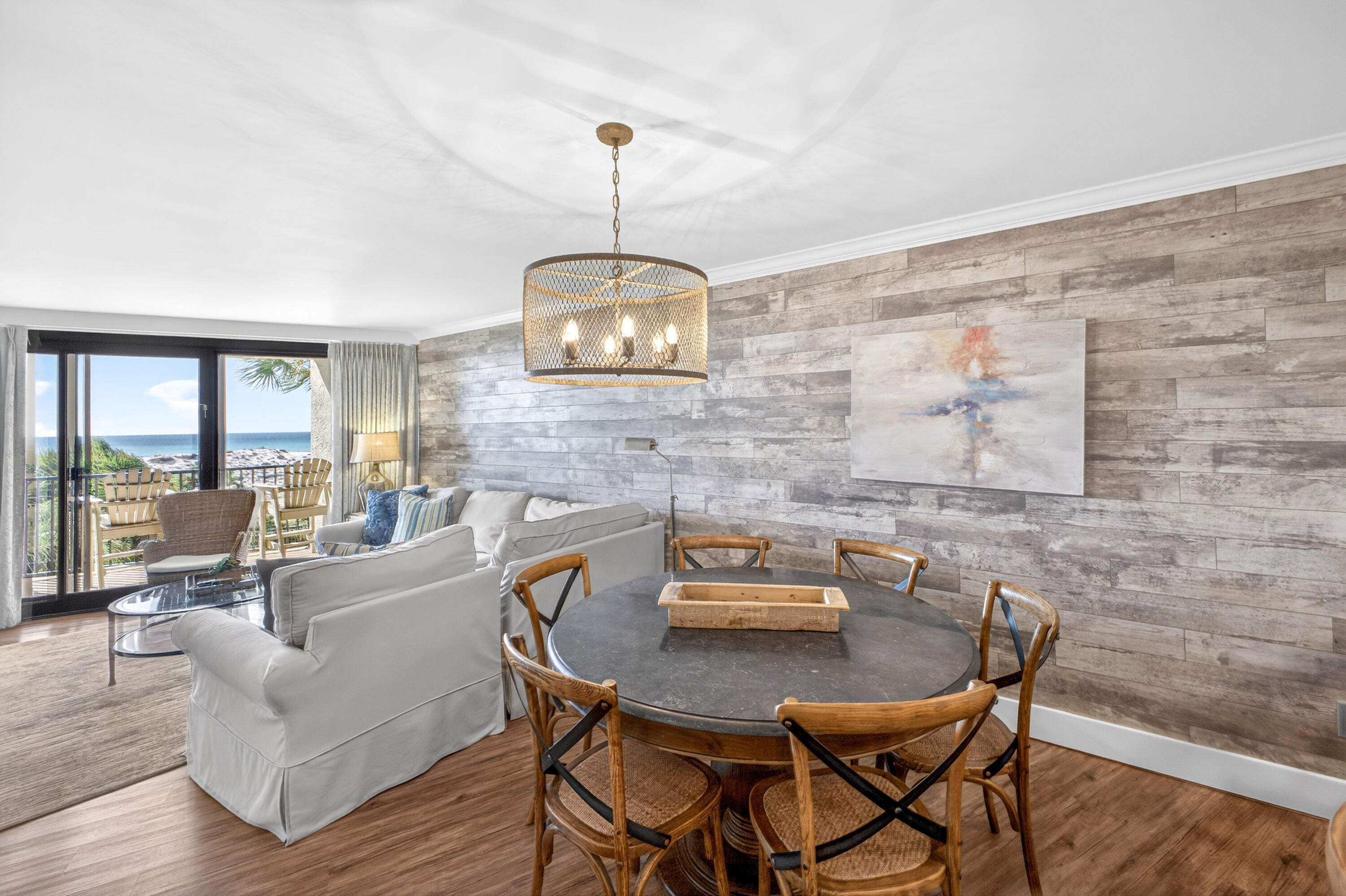 4024 Beachside 1, Unit 4024 Miramar Beach, FL 32550 - Photo 2 of 56 a view of a dining room with furniture wooden floor and a chandelier