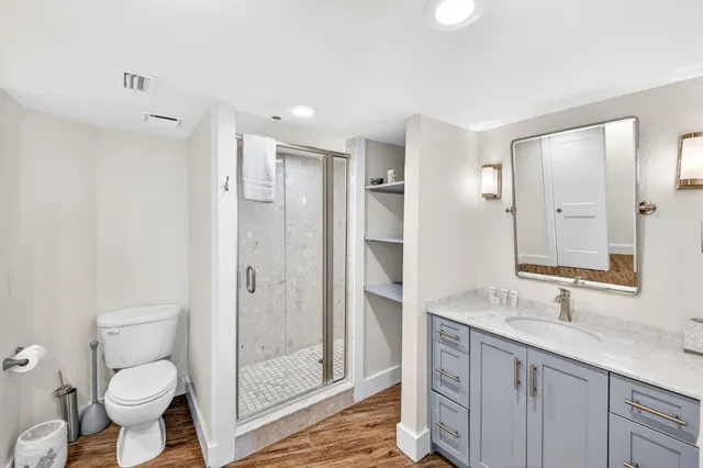 a view of a balcony with wooden chairs and floor to ceiling window