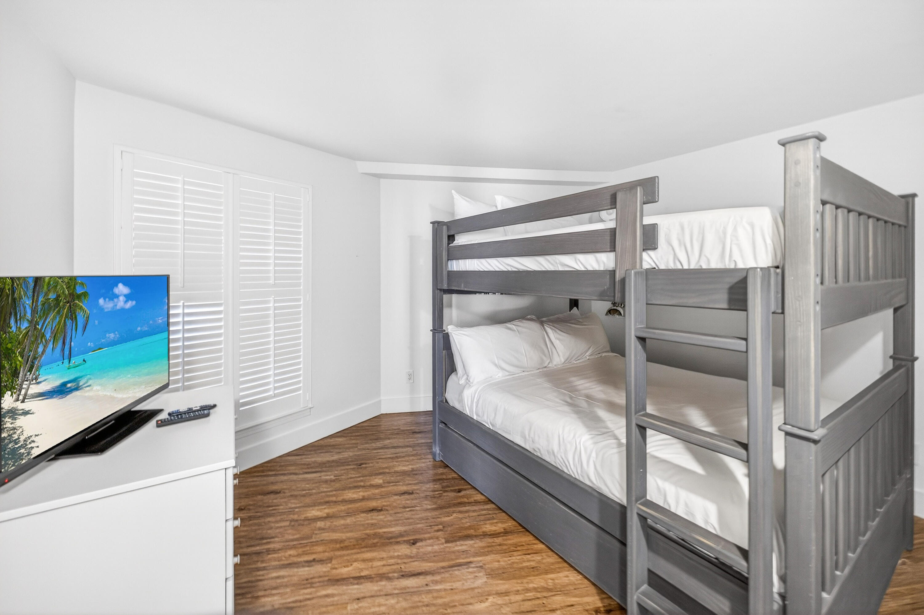 4024 Beachside 1, Unit 4024 Miramar Beach, FL 32550 - Photo 25 of 56 a bedroom with a bed and a flat screen tv