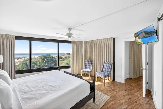 a bedroom with a bed and a large window