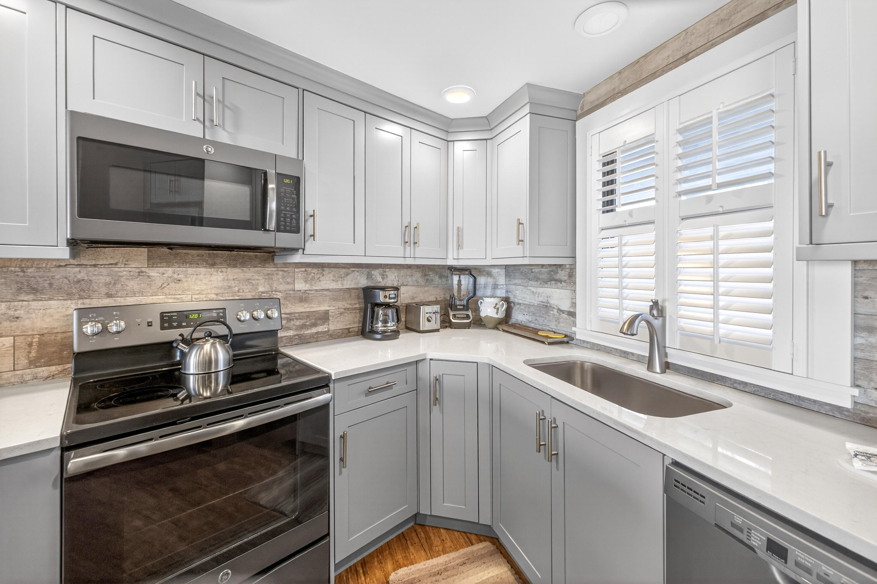 4024 Beachside 1, Unit 4024 Miramar Beach, FL 32550 - Photo 6 of 56 a kitchen with stainless steel appliances granite countertop a sink stove and microwave