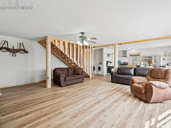 a living room with furniture and wooden floor