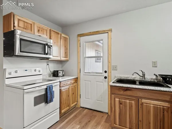 a kitchen with white cabinets and white appliances