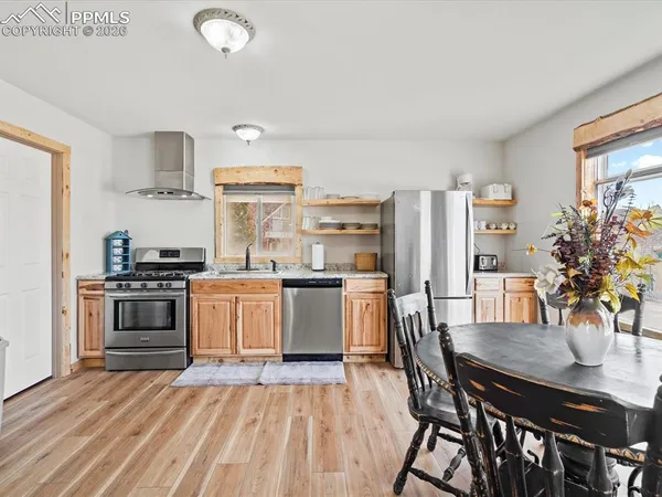 a kitchen with a white stove top oven and refrigerator