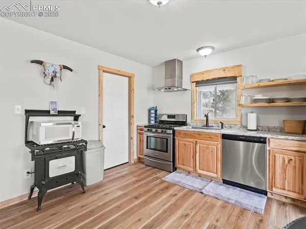 a kitchen with a stove a sink and a refrigerator