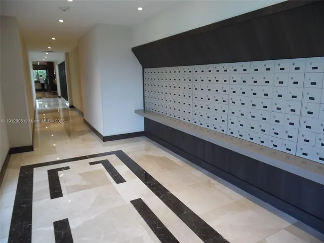 a living room with furniture and large windows