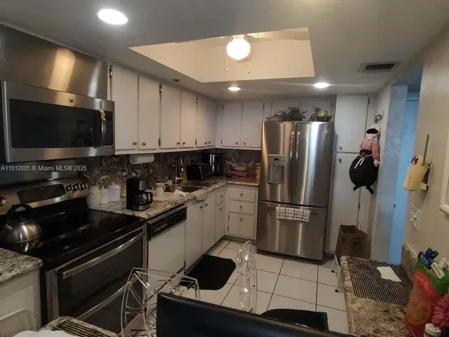 a large bathroom with a double vanity sink a mirror and a shower