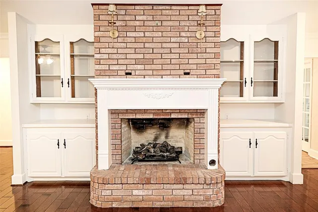 a living room with a fireplace and a floor to ceiling window